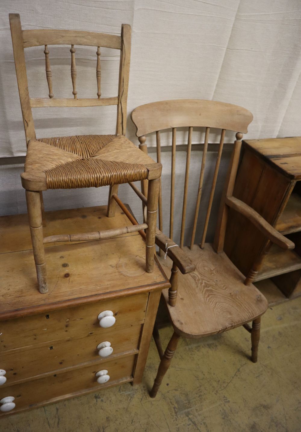 A Victorian elm and beech comb back Windsor armchair and a rush seated childs chair